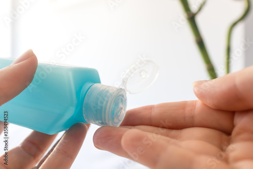 Female hands using hand sanitizer gel. The concept of hand disinfection photo