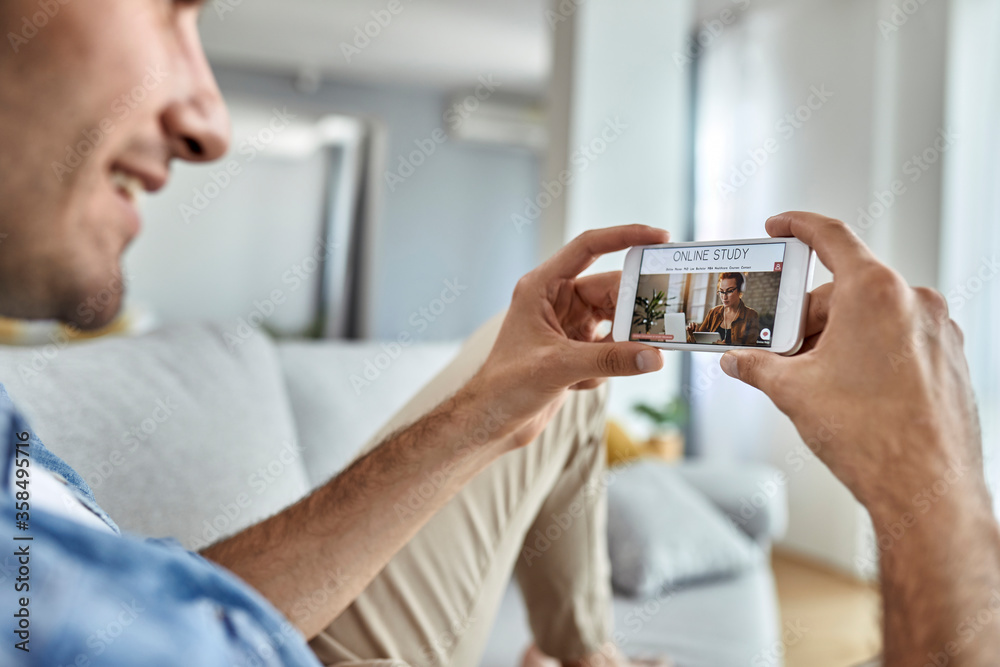 Close-up of a man e-learning over smart phone. Close-up of a man e-learning over smart phone.