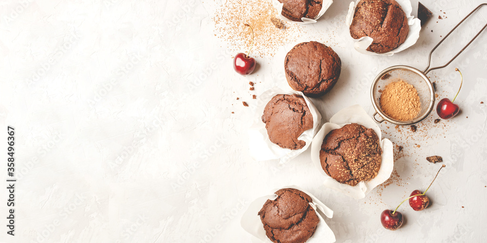Homemade fresh chocolate muffins with berries and chocolate pieces. Top view. Homemade fresh chocolate muffins with berries and chocolate pieces. Top view.