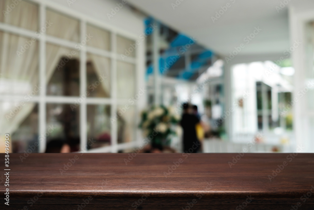 Empty wooden table space platform and blurred restaurant or coffee shop background for product display montage.