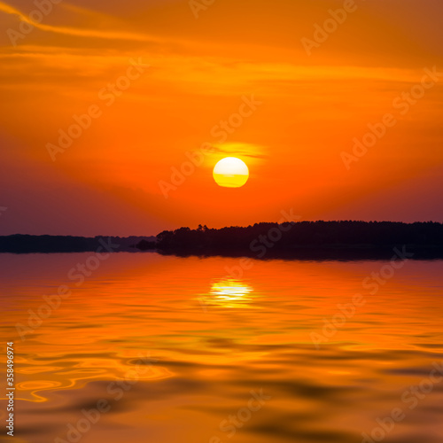 Fototapeta Naklejka Na Ścianę i Meble -  red dramatic sunset over the quiet lake