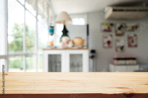 Empty wooden table space platform and blurred restaurant or coffee shop background for product display montage.