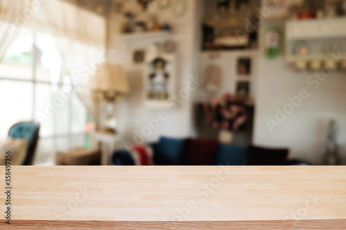 Wooden desk space platform and blurred restaurant or coffee shop background for product display montage.