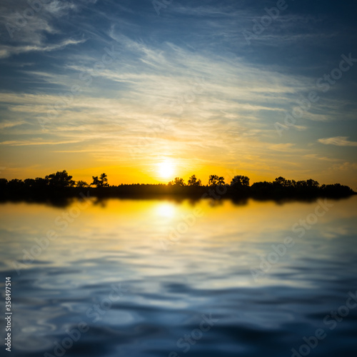 sunset reflected in a water  dramatic countryside outdoor background