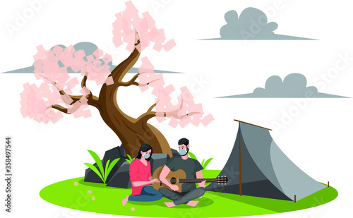 A couple playing music while camping outside