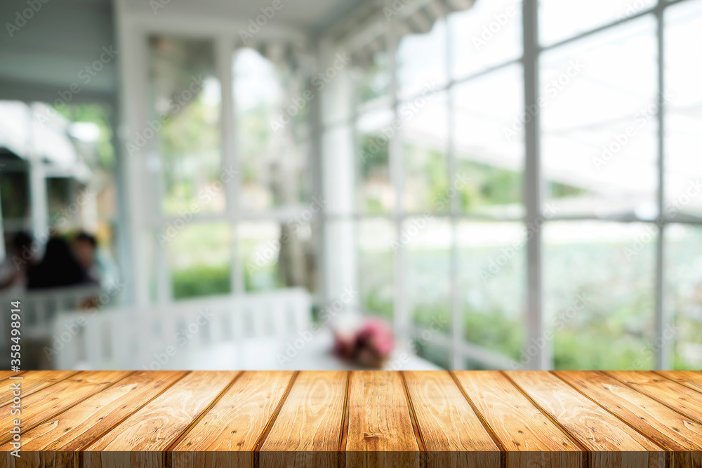 Empty wooden table space platform and blurred restaurant or coffee shop background for product display montage. Empty wooden table space platform and blurred restaurant or coffee shop background for product display montage.