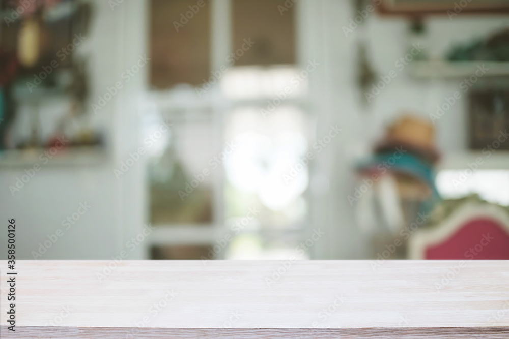 Empty wooden table space platform and blurred restaurant or coffee shop background for product display montage.