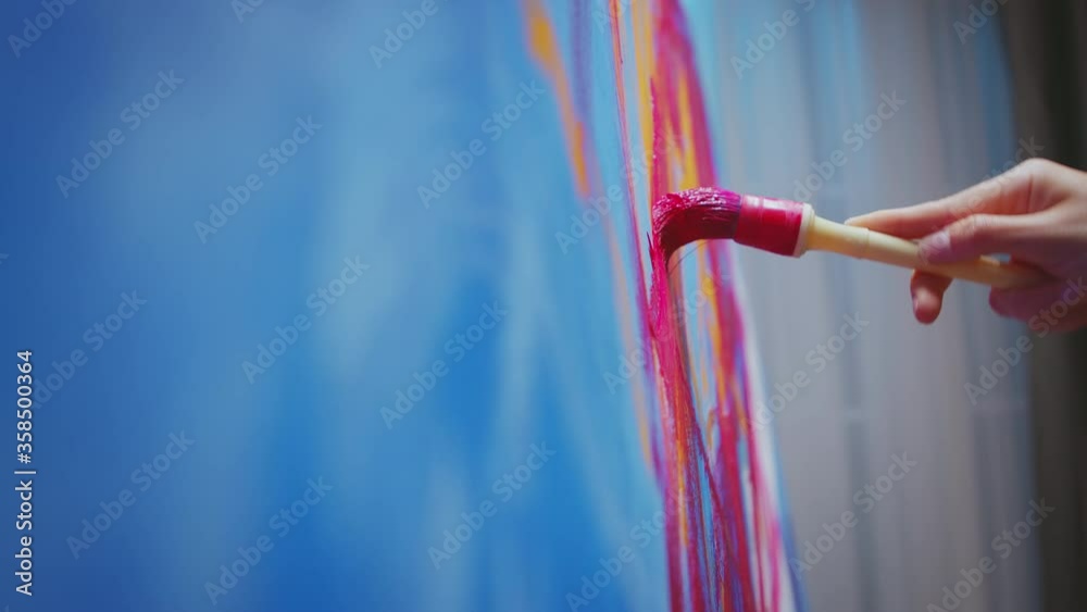 Successful painter making a modern abstract oil painting. Modern artwork paint on canvas, creative, contemporary and successful fine art artist drawing masterpiece