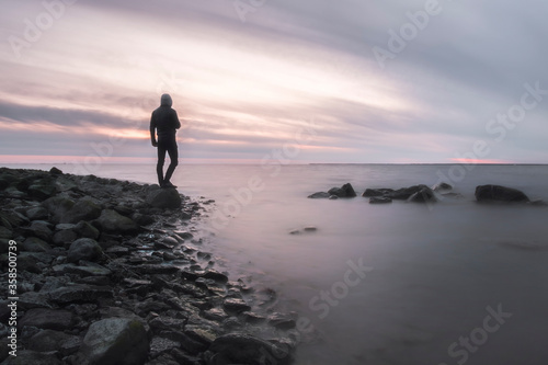 lonely man on the shore of a foggy sea