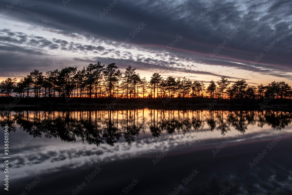 stunningly beautiful view of the evening sky over a forest lake