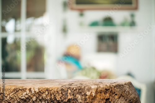 Empty wooden desk space platform over blurred restaurant or coffee shop background for product display montage.