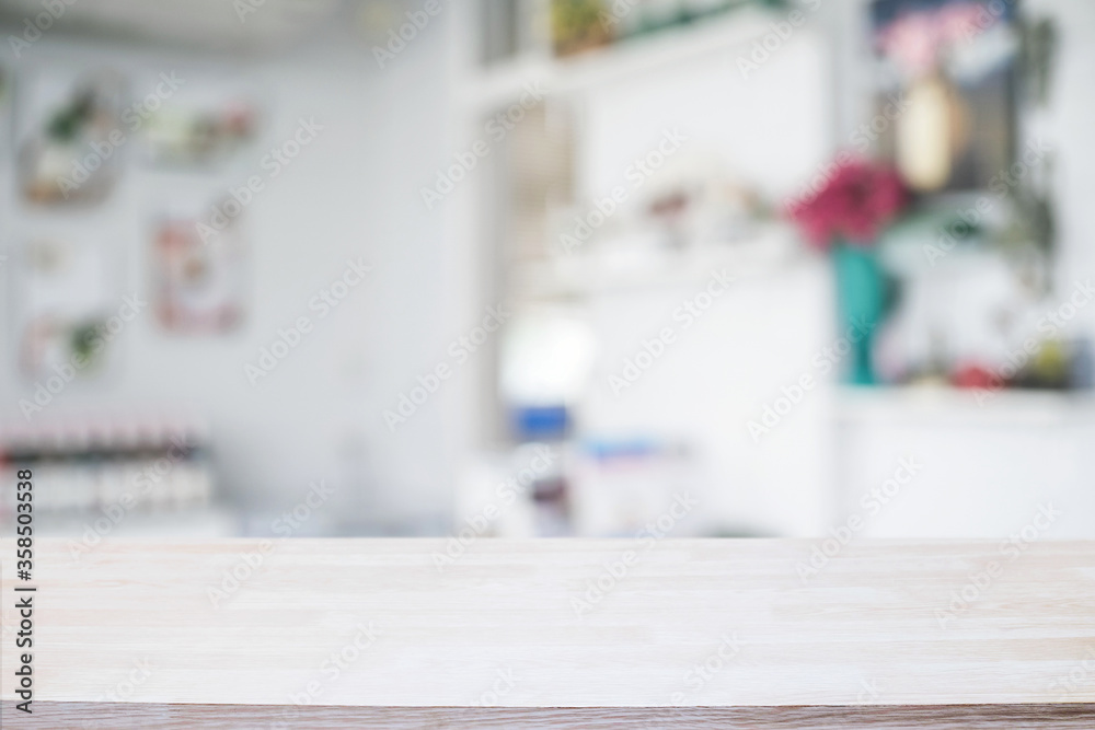 Empty wooden desk space platform over blurred restaurant or coffee shop background for product display montage. Empty wooden desk space platform over blurred restaurant or coffee shop background for product display montage.