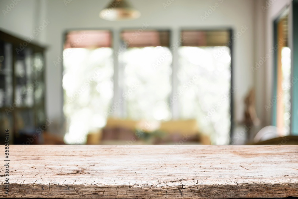 Empty wooden desk space platform over blurred restaurant or coffee shop background for product display montage.