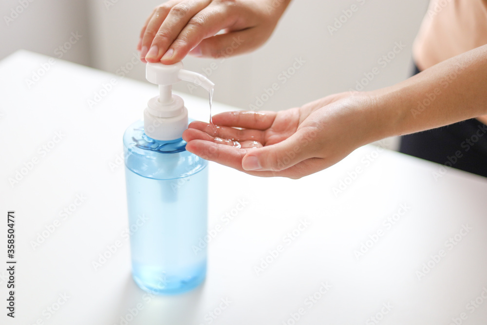 Hand applying Alcohol gel sanitazer liquid cleaning hands for prevent corona virus covid-19.