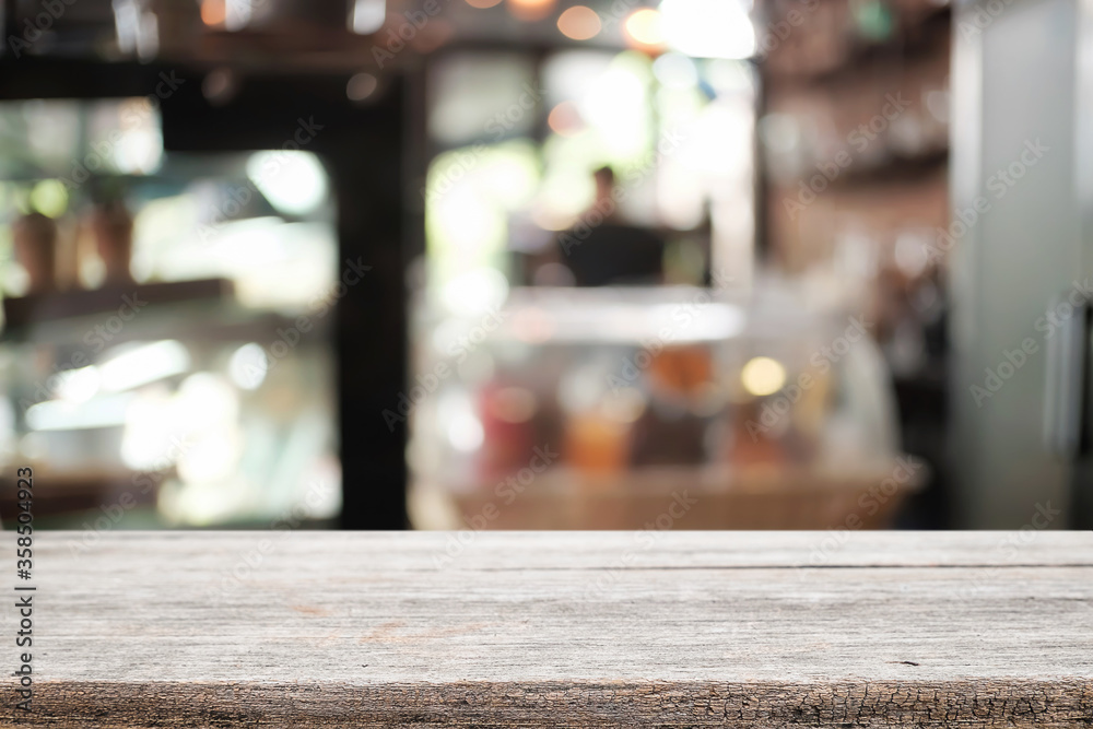 Empty wooden desk space platform over blurred restaurant or coffee shop background for product display montage. Empty wooden desk space platform over blurred restaurant or coffee shop background for product display montage.