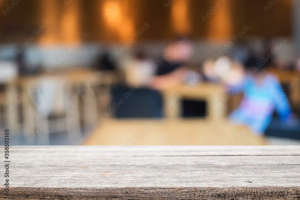 Empty wooden table space platform and blurred restaurant or coffee shop background for product display montage. Empty wooden table space platform and blurred restaurant or coffee shop background for product display montage.