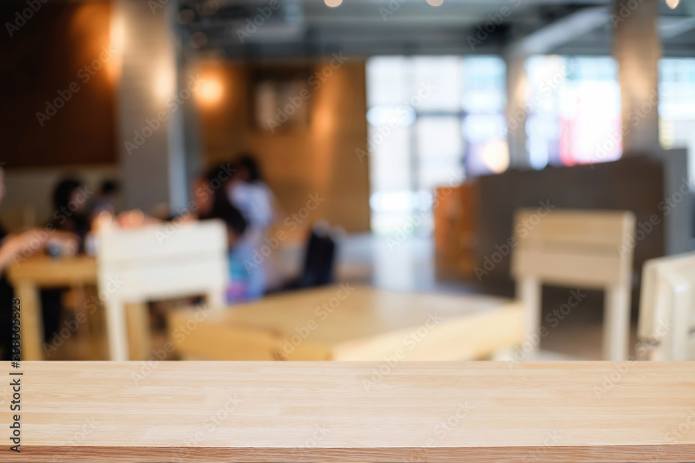 Empty wooden table space platform and blurred restaurant or coffee shop background for product display montage.