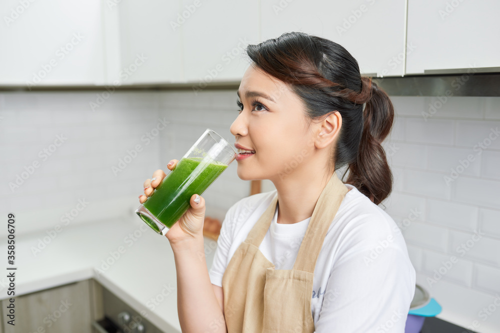 Healthy Lifestyle Concept. Close up portrait of smiling girl drinking morning smoothie made of super foods Healthy Lifestyle Concept. Close up portrait of smiling girl drinking morning smoothie made of super foods