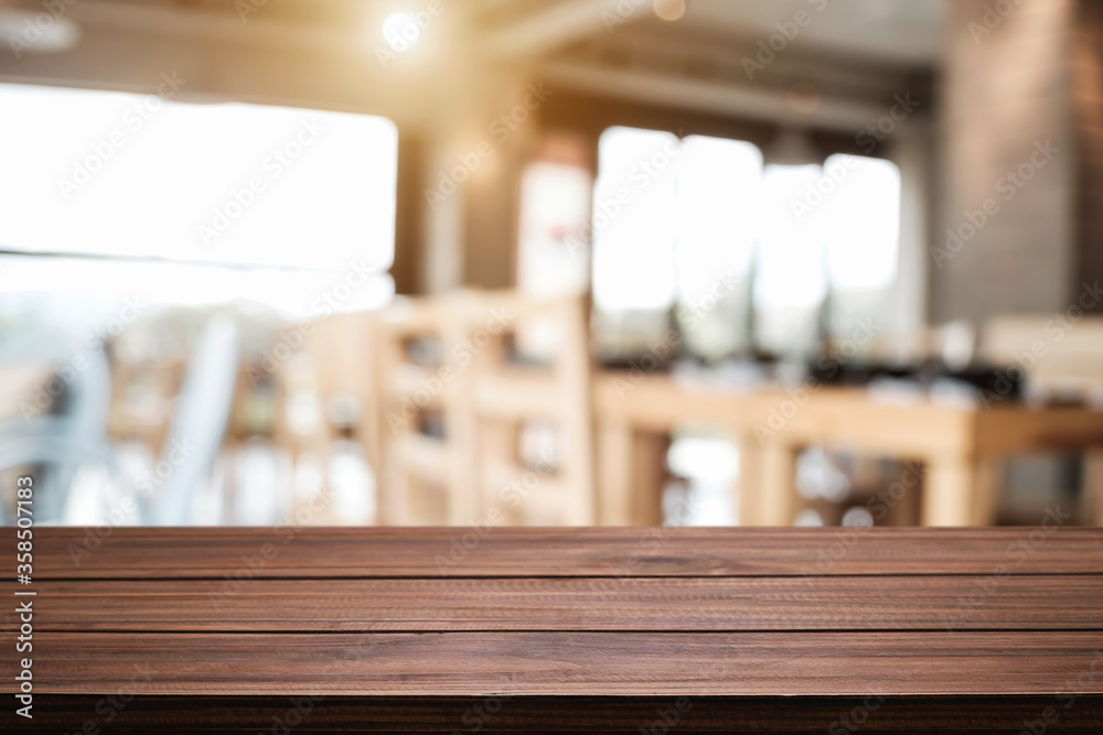 Empty wooden desk space platform with blur restaurant or coffee shop background for product display montage. Empty wooden desk space platform with blur restaurant or coffee shop background for product display montage.