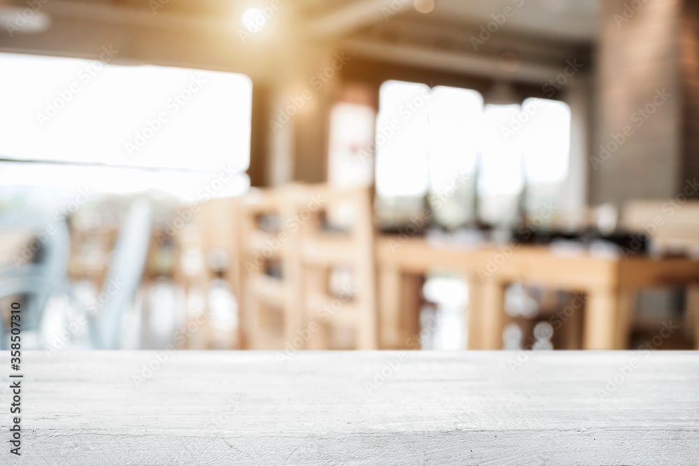 Empty wooden desk space platform with blur restaurant or coffee shop background for product display montage. Empty wooden desk space platform with blur restaurant or coffee shop background for product display montage.