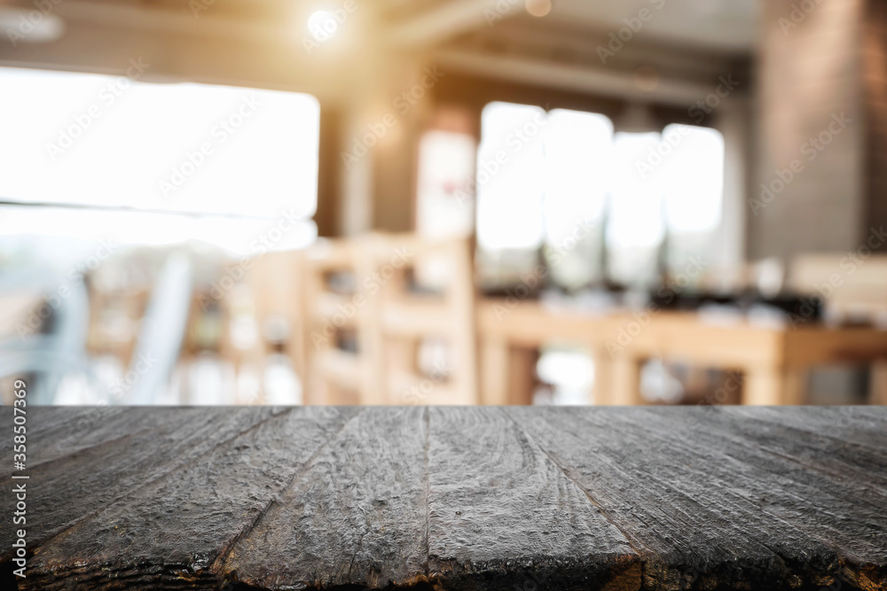 Empty wooden desk space platform with blur restaurant or coffee shop background for product display montage. Empty wooden desk space platform with blur restaurant or coffee shop background for product display montage.