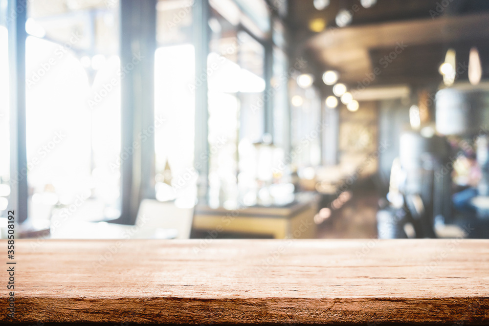 Empty wooden table space platform and blurred resturant or coffee shop background for product display montage. Empty wooden table space platform and blurred resturant or coffee shop background for product display montage.