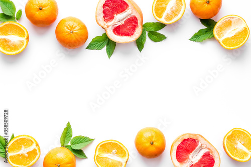 Citrus fruits frame on white background top view