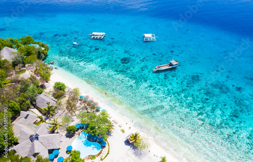 Summer travel concept with Aerial view of white sand beach and seashore at Sumilon island beach Oslob, Cebu, Philippines