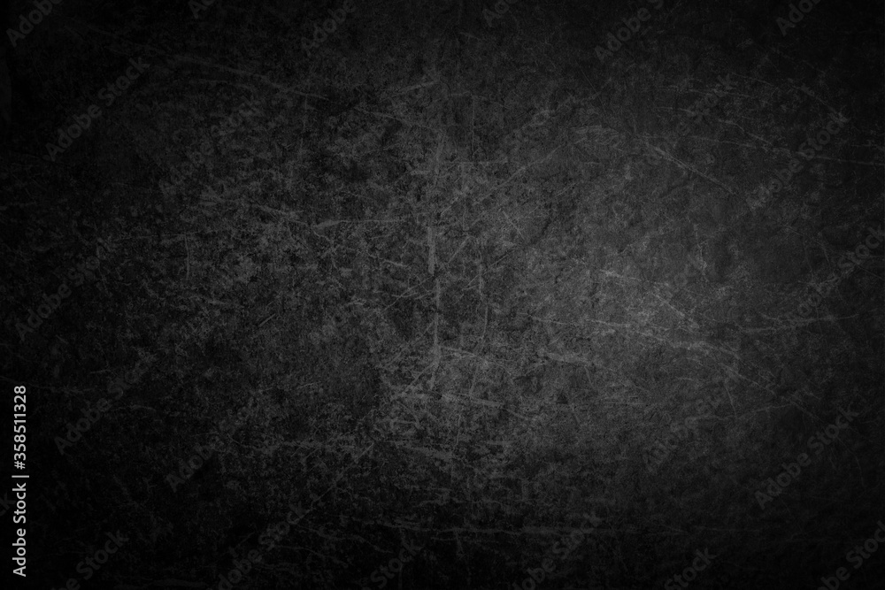 Dark flat scratched rock texture with center soft light Dark flat scratched rock texture with center soft light