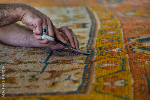 Cutting the fuzz of carpet after it is restored, Turkey