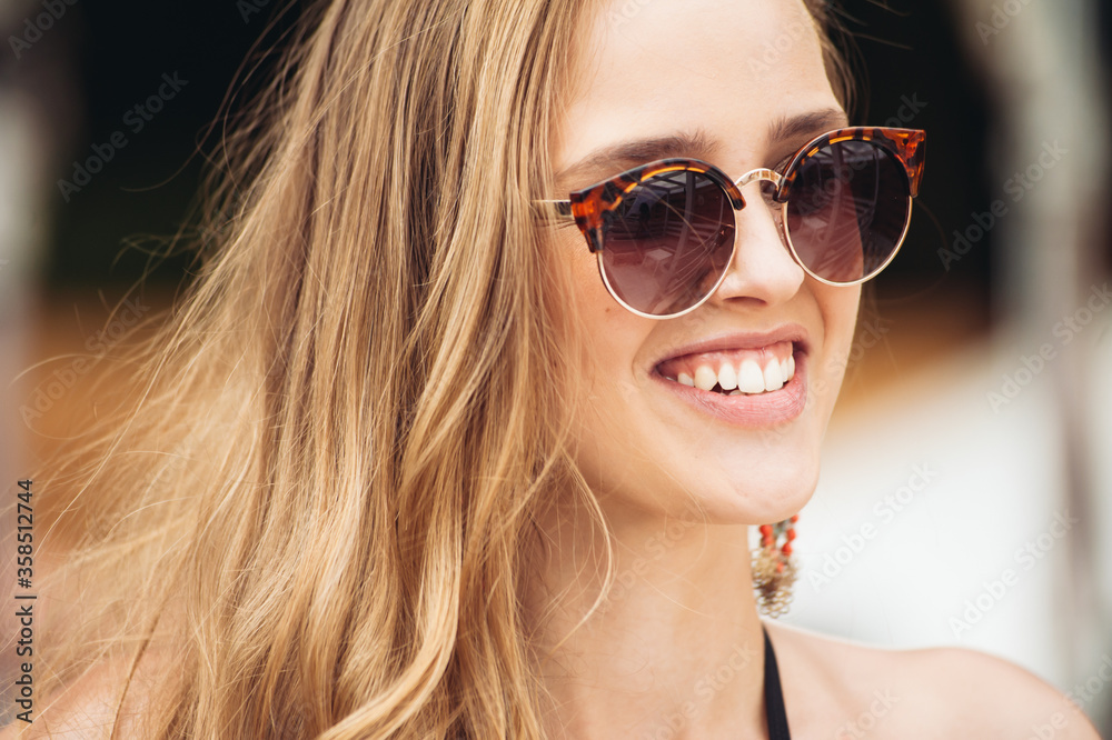 Beautiful smiling young woman in sunglasses Beautiful smiling young woman in sunglasses