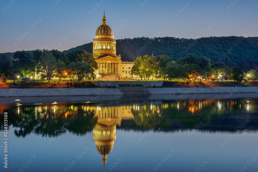 Fototapeta premium Charleston, capitol of West Virginia, reflected in the Kanawha River at sunrise.