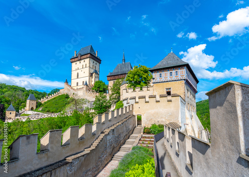 View of the famous Karlstejn castle, Czech republic. Castle built in gothic style by king and emperor of Roman rise, Charles IV. Czech historic heritage, beautiful summer day.