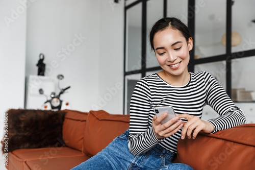 Attractive smiling young asian woman wearing casual clothes