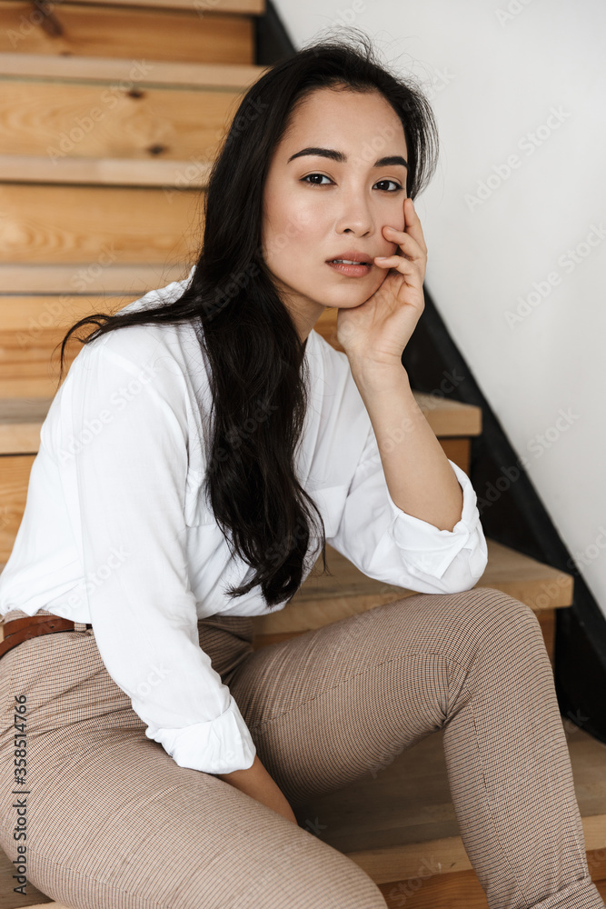 Smiling attractive young asian woman wearing white shirt Smiling attractive young asian woman wearing white shirt