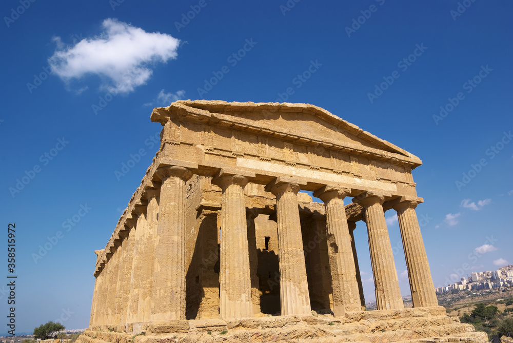 Temple Of Concordia And White Cloud In The Valley Of Temples In Agrigento, A Sicily Landmark Of Unesco Architecture Temple Of Concordia And White Cloud In The Valley Of Temples In Agrigento, A Sicily Landmark Of Unesco Architecture