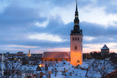 Roof and tower of old town. Winter panoramic aerial view by evening. Tallinn, Estonia.