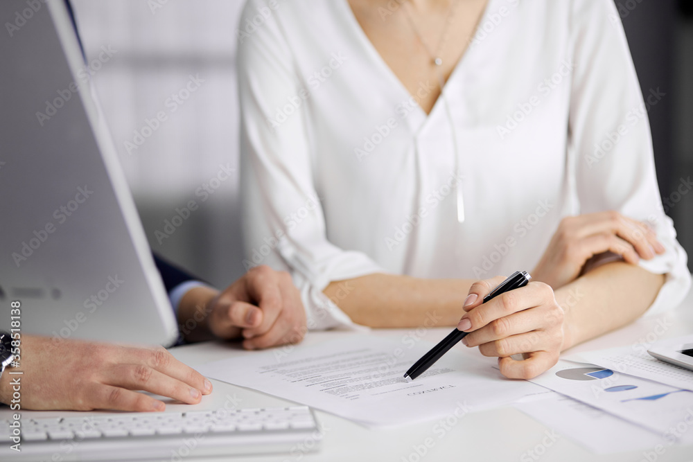 Unknown businessman and woman discussing contract in office. closeup.Business people or lawyers working together at meeting. Teamwork and partnership Unknown businessman and woman discussing contract in office. closeup.Business people or lawyers working together at meeting. Teamwork and partnership