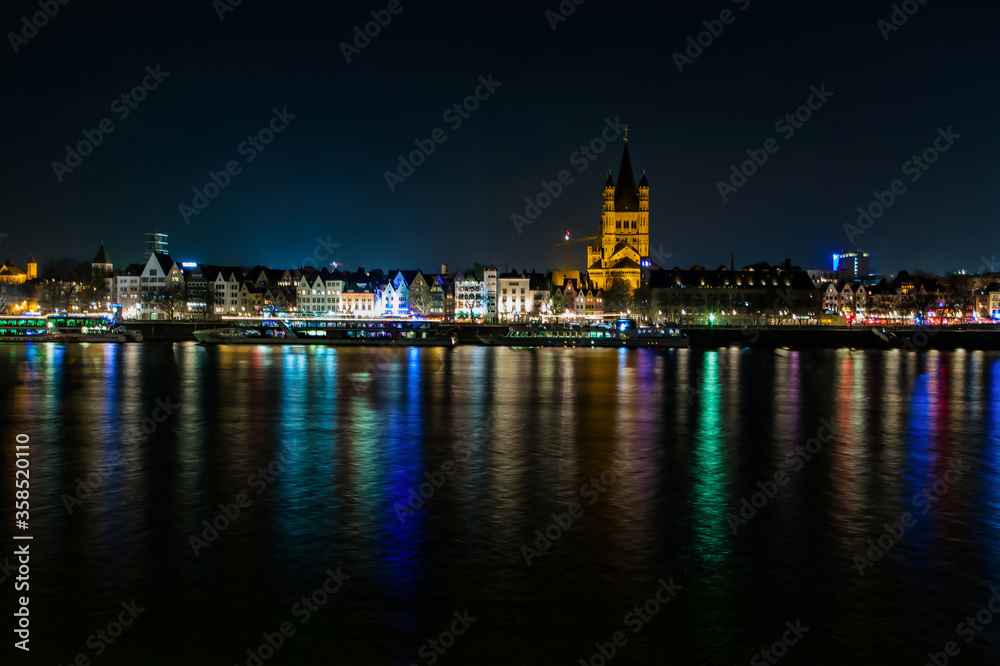 Cologne,Germany,22 february2019..view of the promenade of Cologne illuminated by bright colored lights at night from the opposite shore
