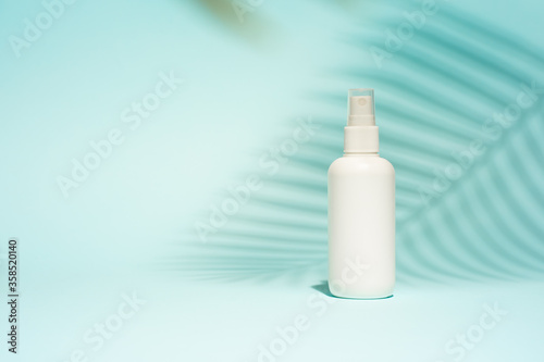 White container for spray on blue background