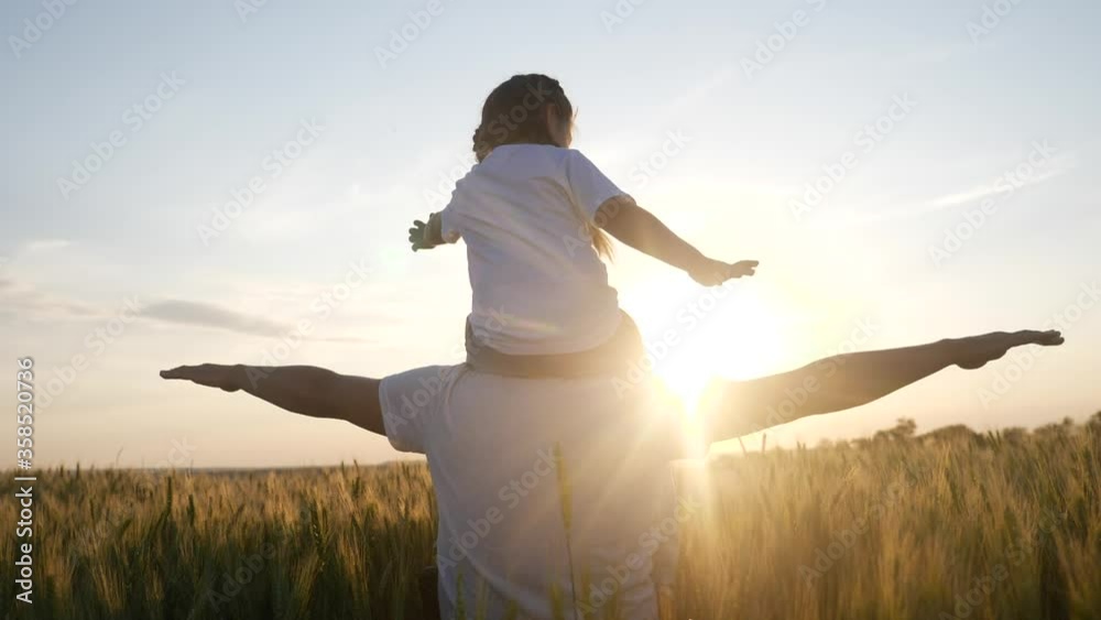 happy family silhouette teamwork concept slow motion video. daughter little girl sitting on his father man neck depicts a flight of an airplane playing a pilot. dad and child kid daughter lifestyle happy family silhouette teamwork concept slow motion video. daughter little girl sitting on his father man neck depicts a flight of an airplane playing a pilot. dad and child kid daughter lifestyle