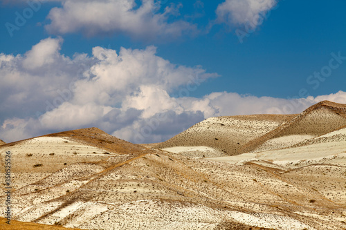 close up rock mountain with blue sky and clouds.