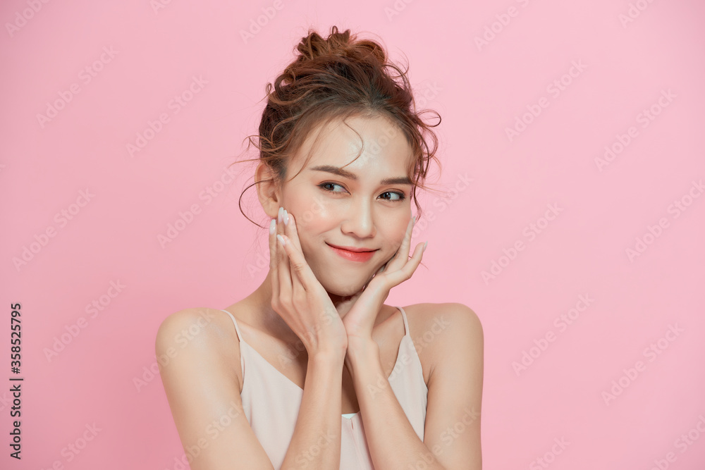 Happy beautiful girl holding her cheeks with a laugh looking to the side. Pretty woman clean fresh skin Happy beautiful girl holding her cheeks with a laugh looking to the side. Pretty woman clean fresh skin