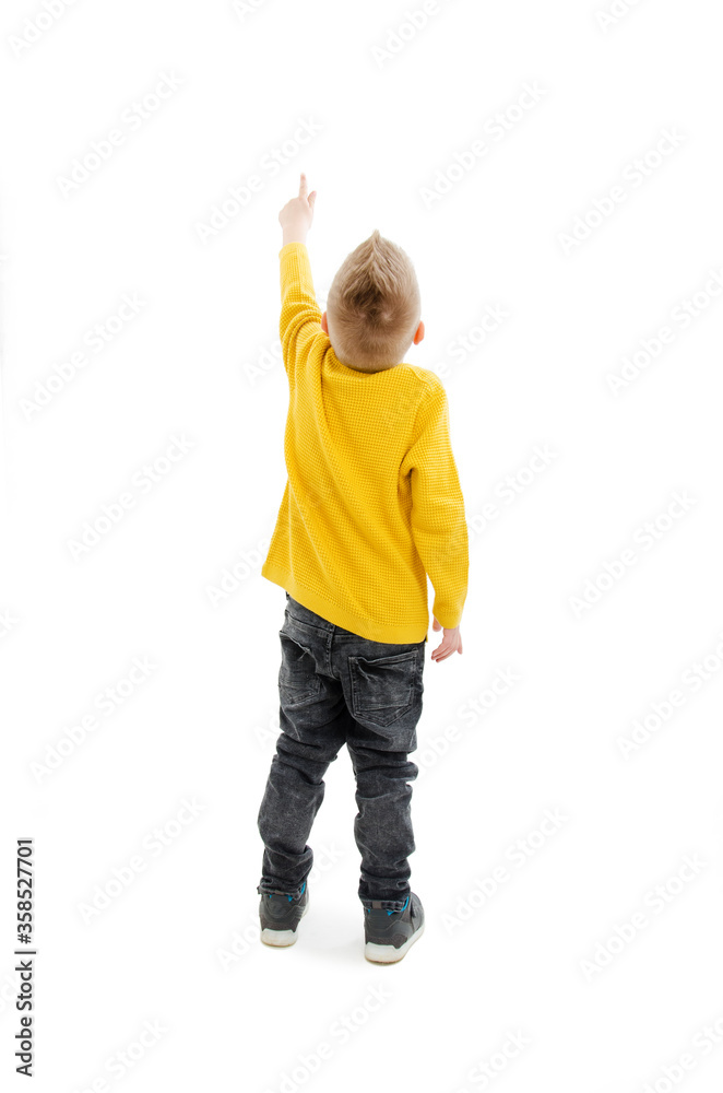 Back view of little boy points at wall. Rear view. Isolated on white background
Back view of little boy points at wall. Rear view. Isolated on white background