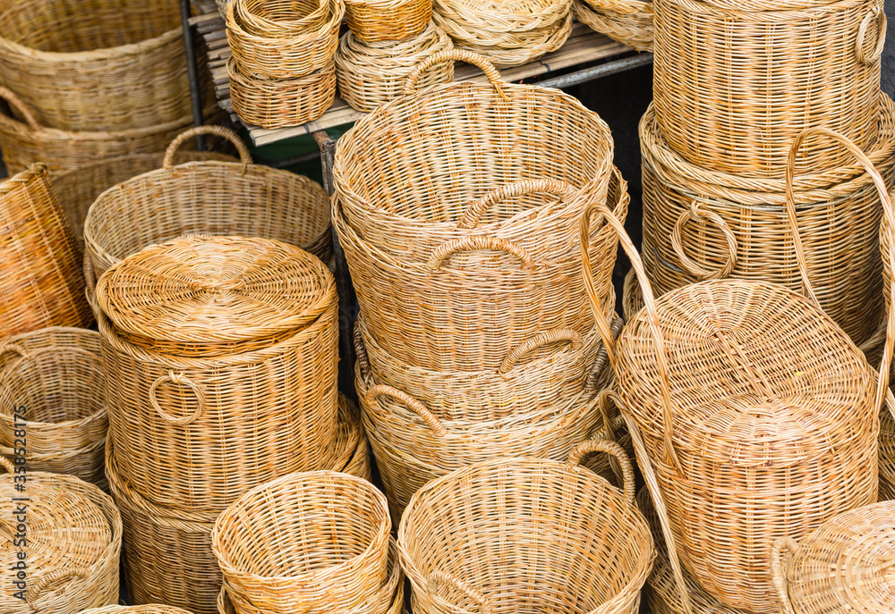 Variety of many handmade wicker baskets displayed for sale at a local flea market stall. Variety of many handmade wicker baskets displayed for sale at a local flea market stall.