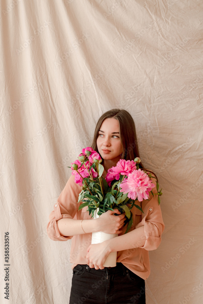 young woman with bouquet of peonies