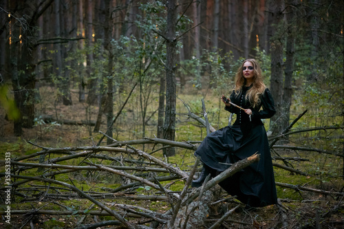 girl witch witch in a dark pine forest