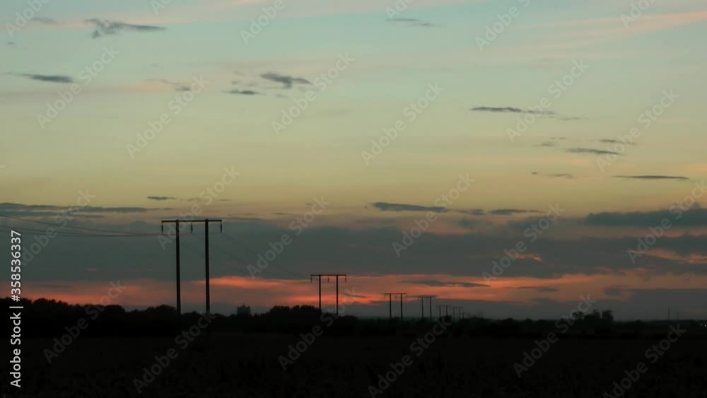 The sun setting sky clouds in the UK countryside. Time lapse shot. The sun setting sky clouds in the UK countryside. Time lapse shot.