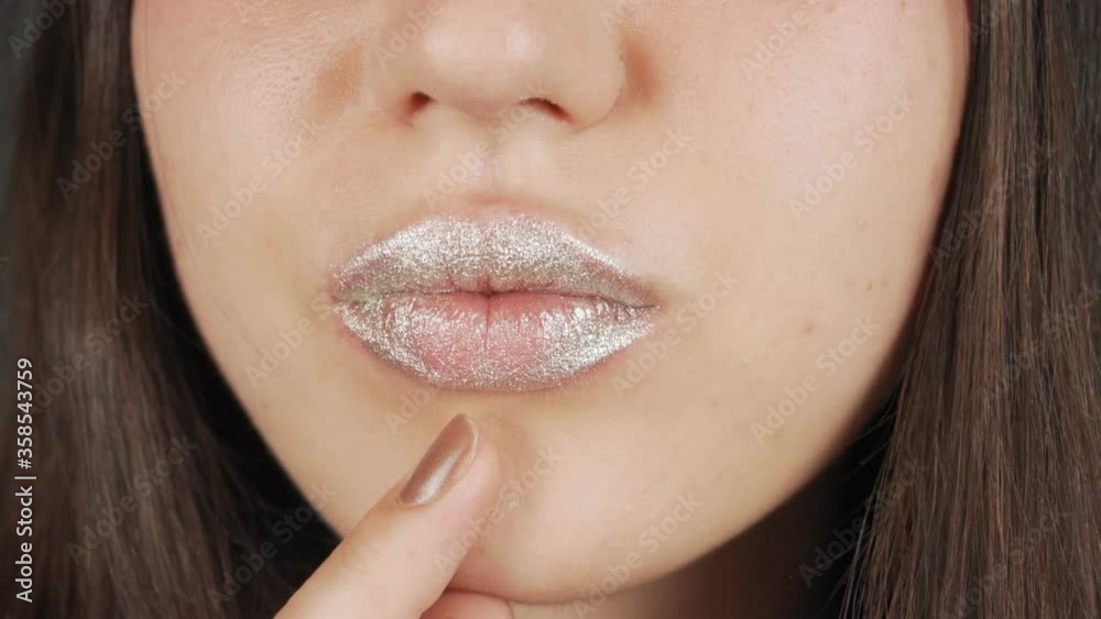 Fashion model woman lips in bright sparkles, beautiful sexy lips. Extreme close-up of full lips. Fashion model woman lips in bright sparkles, beautiful sexy lips. Extreme close-up of full lips.