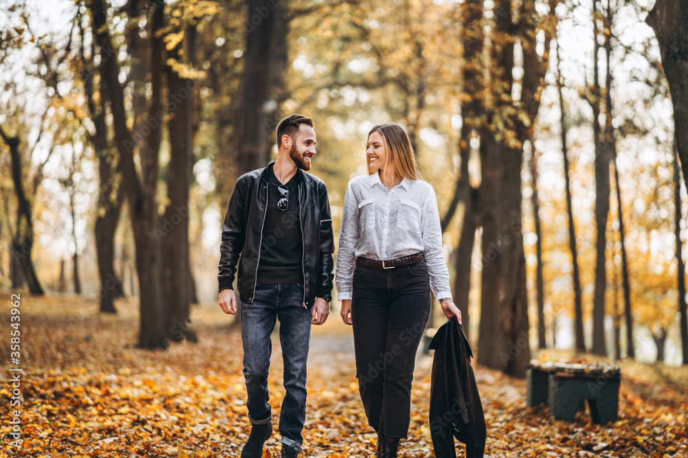Portrait of a happy loving couple walking outdoor in the autumn park Portrait of a happy loving couple walking outdoor in the autumn park
